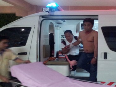 Shot police officer Nikom arrives at a Phuket hospital early today