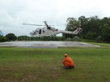 The helicopter lands at Racha to pick up the stricken woman