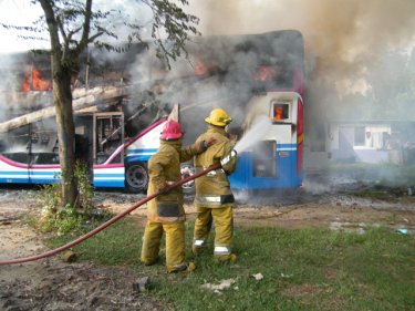 Firemen fight a blaze that consumed a seven million baht bus in Phuket City