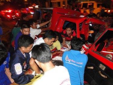 Rescuers remove the tuk-tuk driver from his shattered cabin today