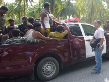 Captive Rohingya crowd into a local police pickup north of Phuket