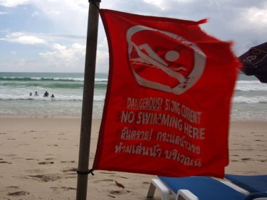 A flag flies on Patong beach where two tourists drowned earlier this year