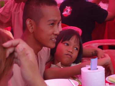 An inmate with a child at today's special family picnic at Phuket Prison