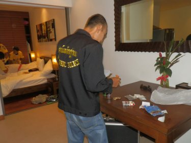 A forensic detective checks the room in which the American was found
