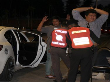 Travellers are searched at Phuket's Tachatchai checkpoint last night