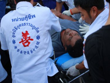 An injured passenger is treated before being taken to Patong Hospital