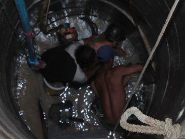 Depths of despair: rescuers try to free a man trapped down a Patong well