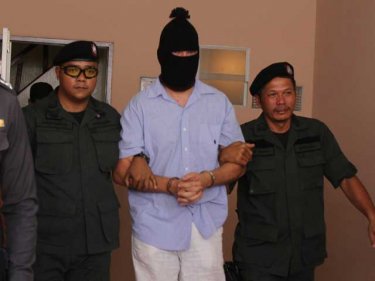 Moshe David is led from a reenactment of December's Phuket murder