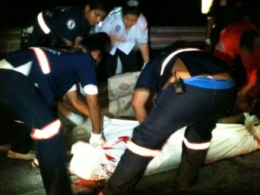 Paramedics shroud the British man's body at the crash scene last night