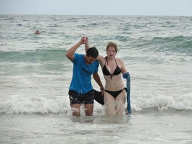 A Russian woman is helped at Karon beach after a rescue in May, 2012