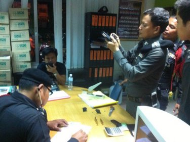 Police check the handgun found in the possession of a Thalang volunteer