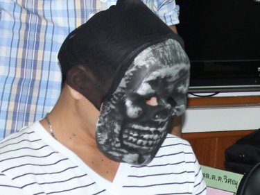 The masked robber puts on his disguise at a media presentation