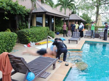 Paramedics remove the man's body from the pool at the luxury villa
