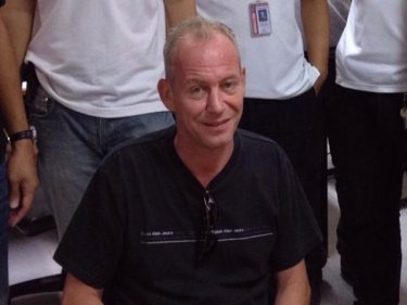 Richard James Daffurn manages a smile after his arrest on Phuket today