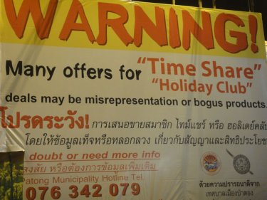 Billboards  in Patong warn against time-share touts in 2011