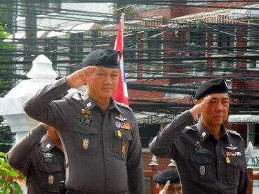 Chief Commissioner General Adul Saengsingkaew takes a salute