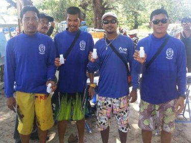 Jet-ski operators at Phuket's Kata beach show off their negative drug tests