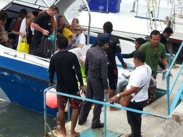 Tourists return after the crash of the speedboats off Phuket