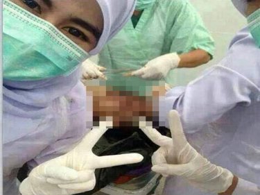 The photograph that caused the fury: Thai nurses pose on Facebook