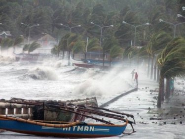 Typhoon Haiyan lashes the Philippines, leaving at least 100 dead