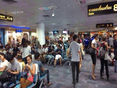 Crowds throng Phuket airport as the storm forces delays, diversions