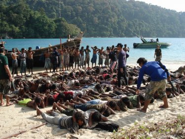The Royal Thai Navy oversees Rohingya on a beach in 2008. Now, in 2013, dealing with human traffickers appears to provide an easier solution