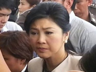 PM Yingluck Shinawatra looks serious as she heads to the hearing