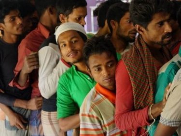 Fleeing Rohingya queue for food after a trip south to Thailand in which they say 12 men were killed by smugglers and thrown overboard