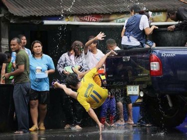 A man tumbles from a pickup during Songkran in Phang Nga today