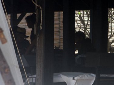 Guests at an illegal restaurant on a Phuket beach defy the military action