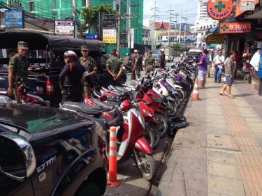Soldiers and police tell motorcycle hirers to move on in Patong today