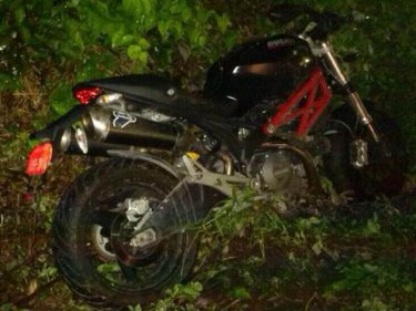 The dead man's Ducati lies beside the ditch on Phuket's coast road