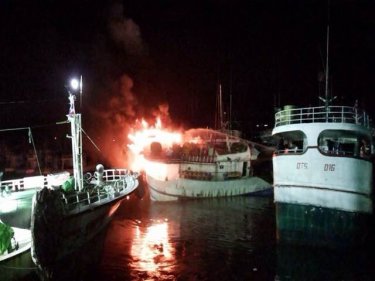 Firelights the nights at Phuket City's Rassada port as a supply boat blazes