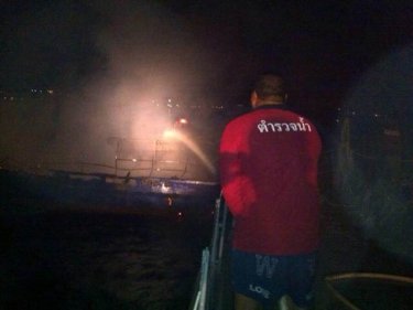 Firefighters battle a blaze on a dive boat off Phuket's Chalong Pier early today