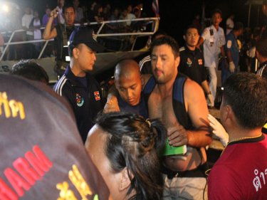 Injured speedboat tourists being helped at Phuket's Rassada pier tonight