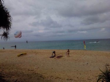 Surin beach today with a parasail operating on the wide sandy spaces
