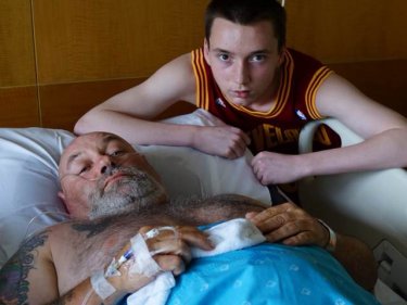 Mauling victim Paul Goudie with son Jake in hospital last week