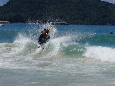 A jet-ski rider jumps a wave at Phuket's Patong beach yesterday