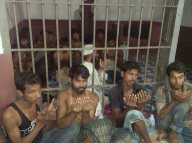 Captive Rohingya pray in a police cell north of Phuket this week
