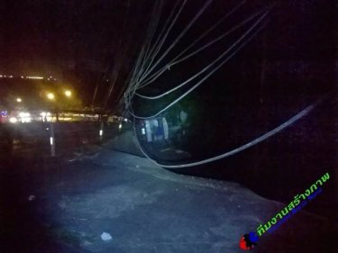 A SuperCheap truck topples two power poles, blocking a lane on Patong Hill