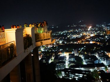Tourists enjoy the new viewing platform at Rang Hill, Phuket City, last night