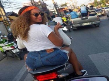 A helmetless Beyonce risks rear-ending a pickup truck on Phuket
