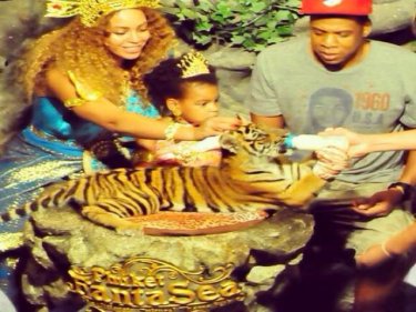 Blue Ivy and folks feed the tiger at FantaSea. Now it's their island home