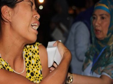 A Burmese reacts to an inoculation jab during the visit last night