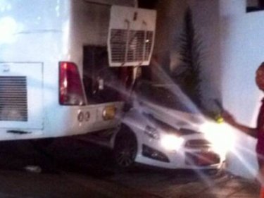 The bus rolled back and crushed a car on Patong's only road north
