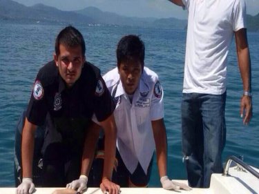 Rescuers carry the British man's body back to Phuket