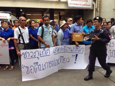 Protesters from Phuket show placards in Bangkok today