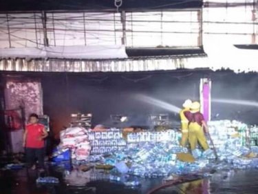 Firemen fight the blaze at the SuperCheap outlet on Phuket today