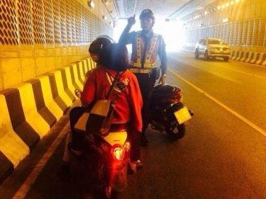 Two wheels are not enough, a policeman tells a rider in Phuket's underpass