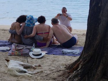 No beach chairs, no problem: tourists enjoying Phuket's Kamala beach